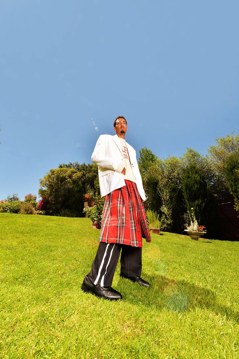 Sweater, Pants, and Loafers TELFAR,
Blazer and Kilt Skirt LOUIS VUITTON