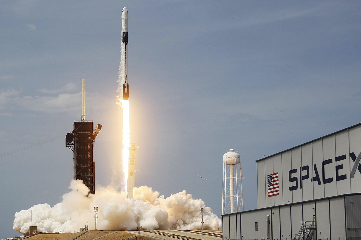 The SpaceX Falcon 9 rocket with the manned Crew Dragon spacecraft attached takes off from launch pad