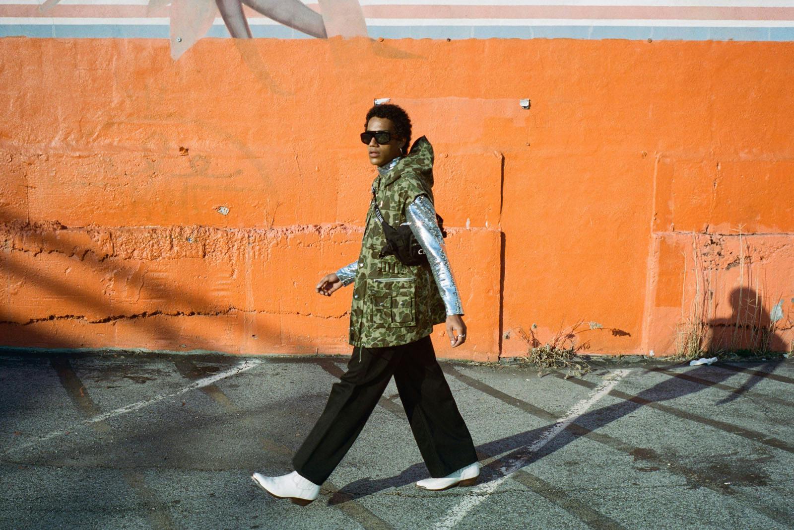 Top, vest, pants, sunglasses, and boots CELINE HOMME BY HEDI SLIMANE Large Zipped Belt Bag Trekking in Nylon with Celine Print CELINE HOMME BY HEDI SLIMANE Jewelry MYLES’S OWN