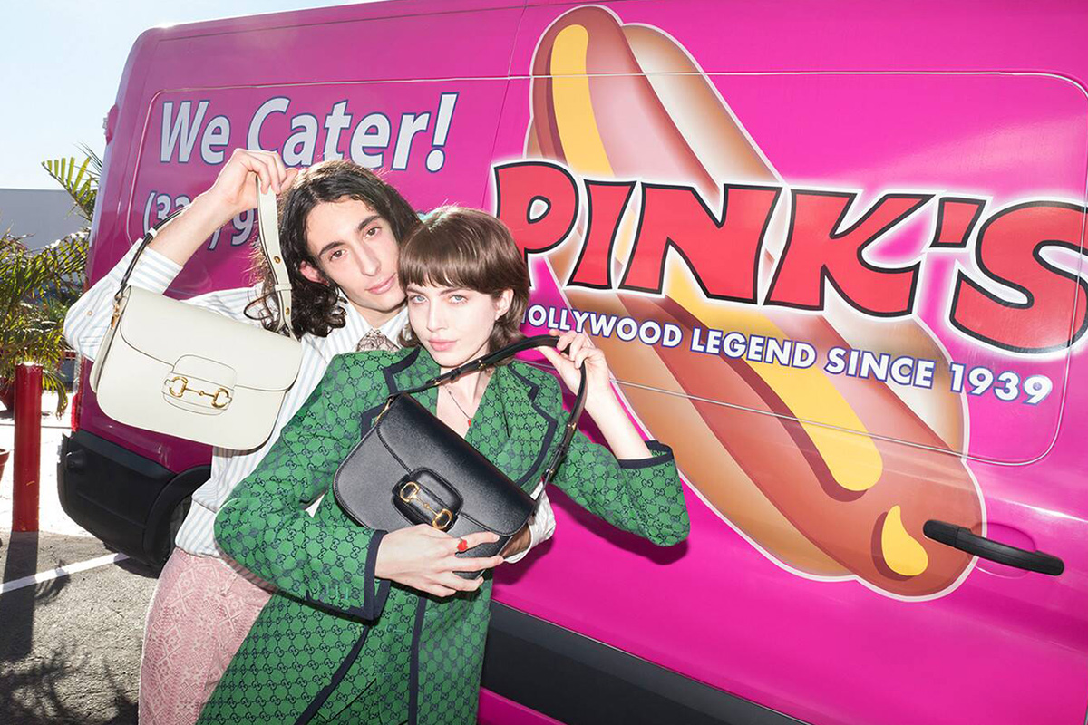 couple posing in front of pink van