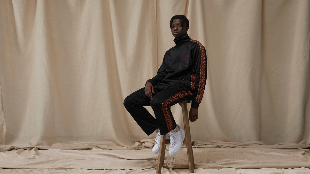 A model wears the END. x Needles track jacket