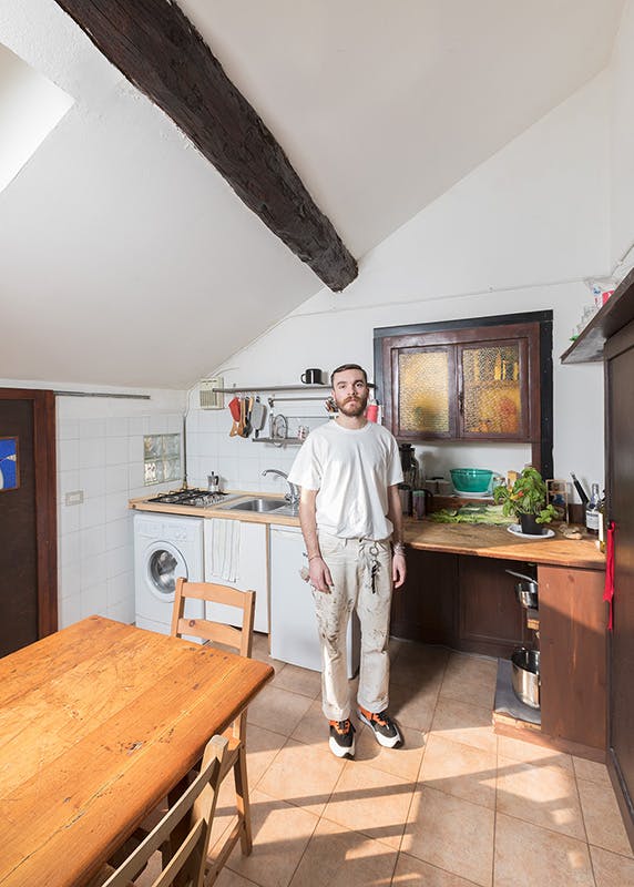Alberto Panocchi wears vintage Dickies work pants and a Supreme t-shirt.