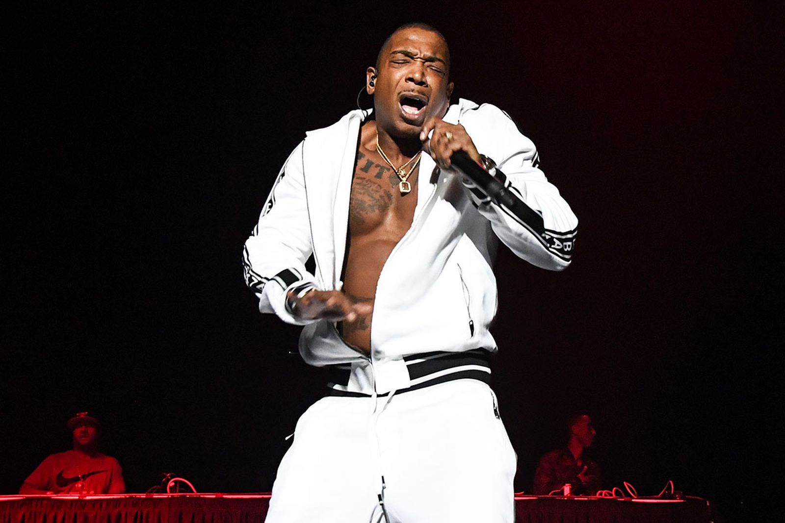 J Rule performs on stage in white tracksuit