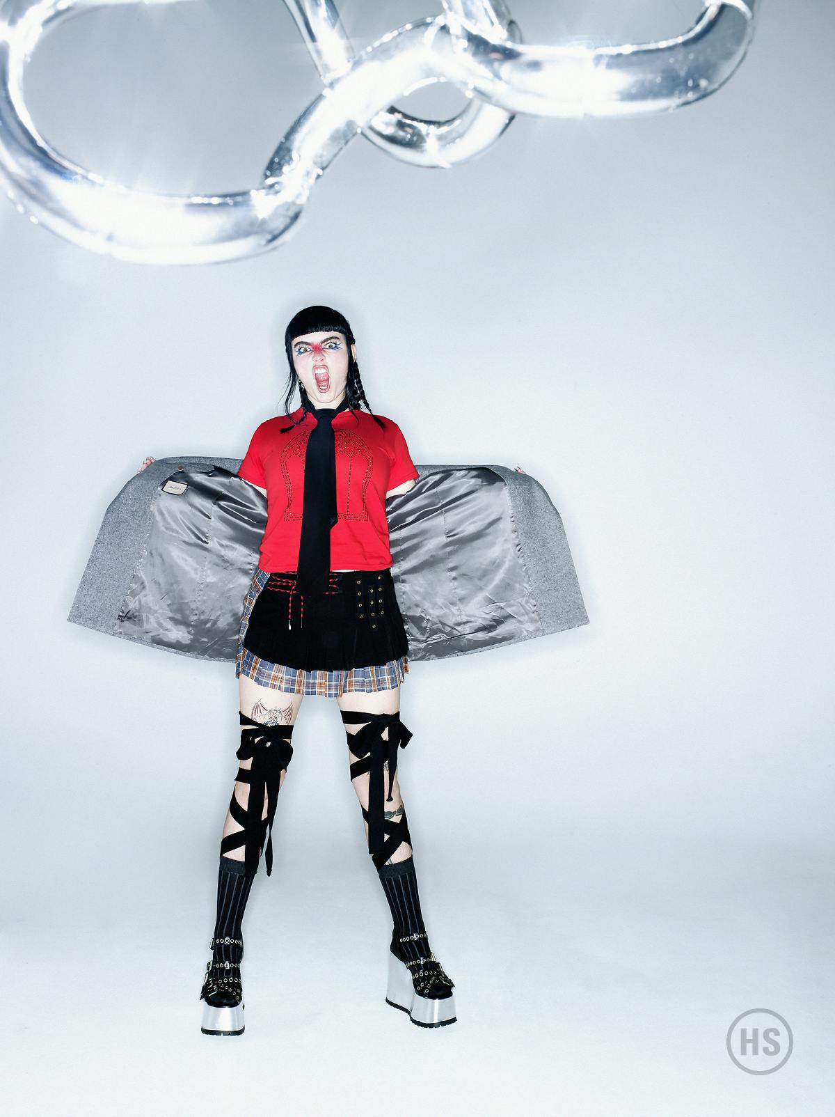Top ANNIE NOA Skirt KARLA LAIDLAW Jacket, tie, and shoes GUCCI Earrings JIWINAIA Rings BENEE’S OWN Socks CATHERINE BODDY