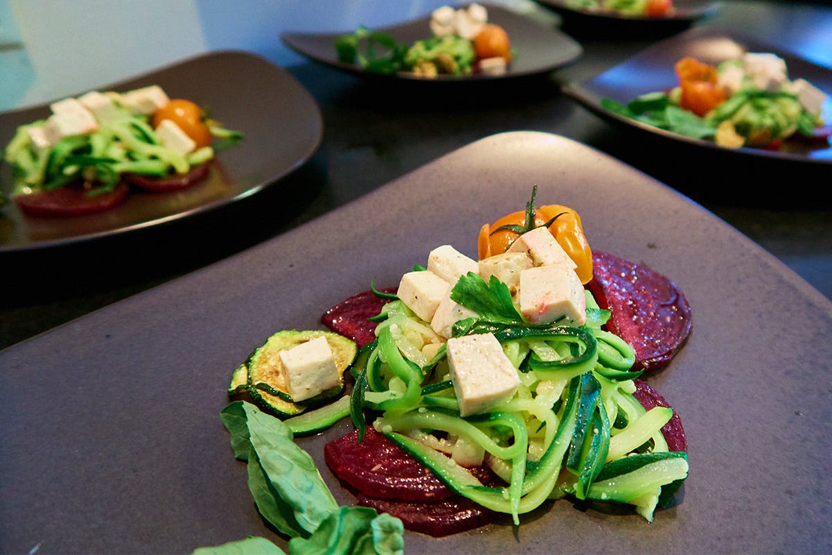 Tofu acts as a great substitute for chicken or beef, as pictured here with a zucchini salad.