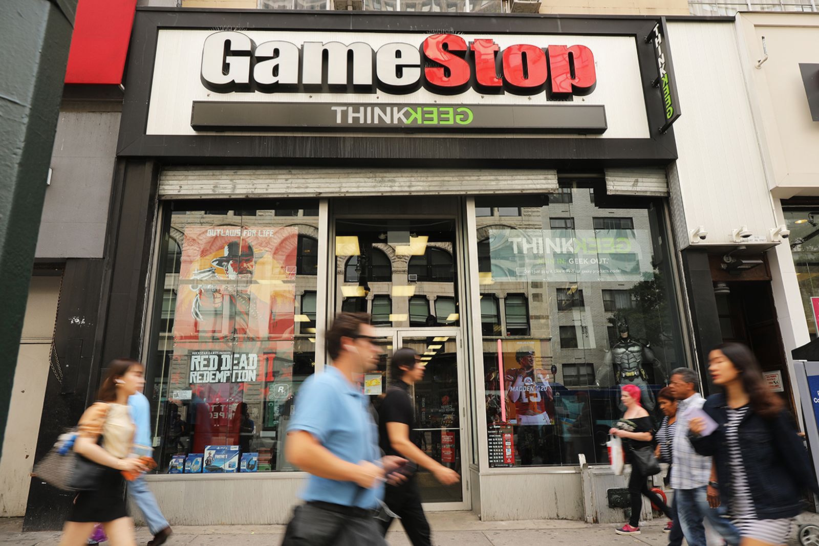 People pass a GameStop store in lower Manhattan